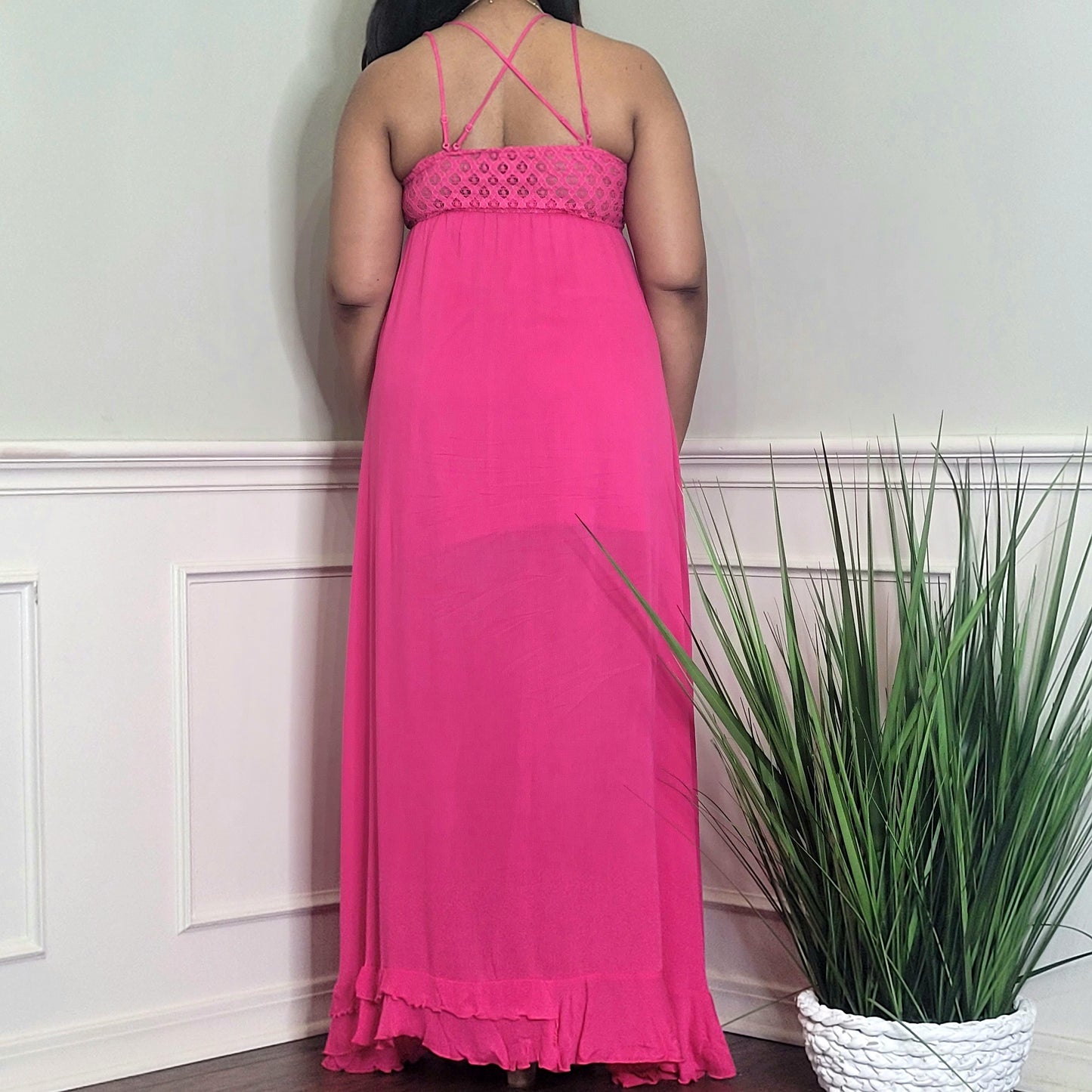 Model wearing a pink crochet top spaghetti strap maxi dress back view
